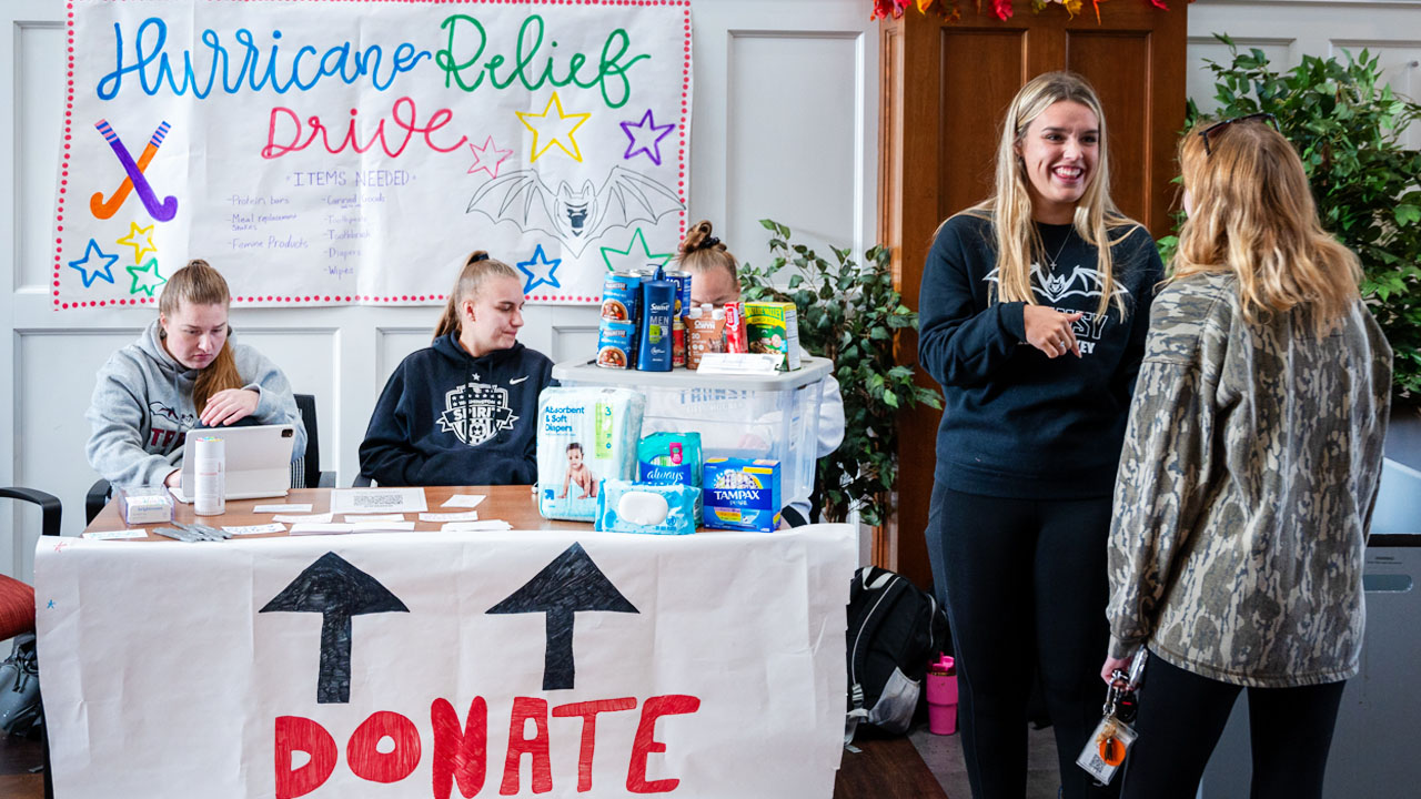 people at a donation booth