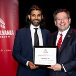 Amit Patel holding award with Brien Lewis
