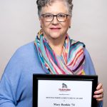 Portrait of Mary Rankin holding award