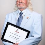 Portrait of Larry Moore holding award