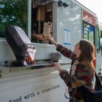 woman being served at food truck