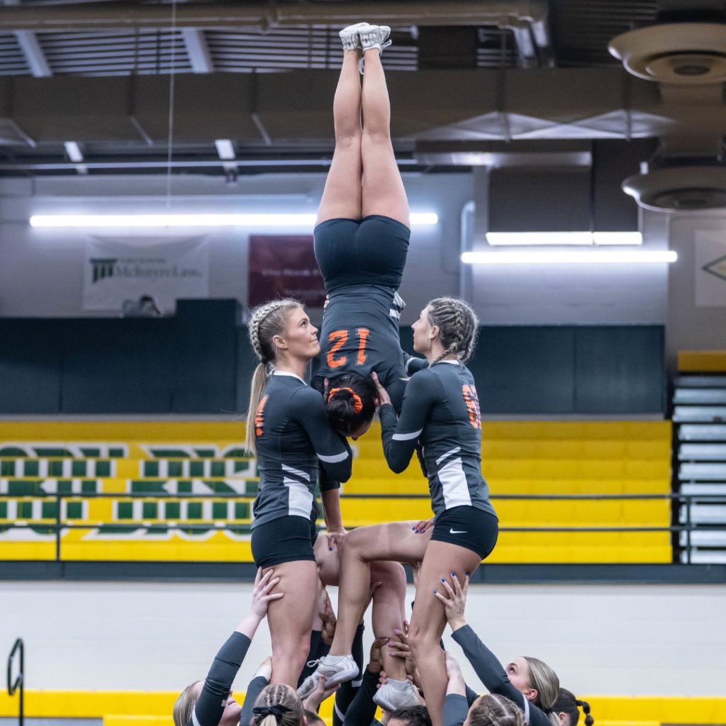 stunt athletes setting up a pyramid