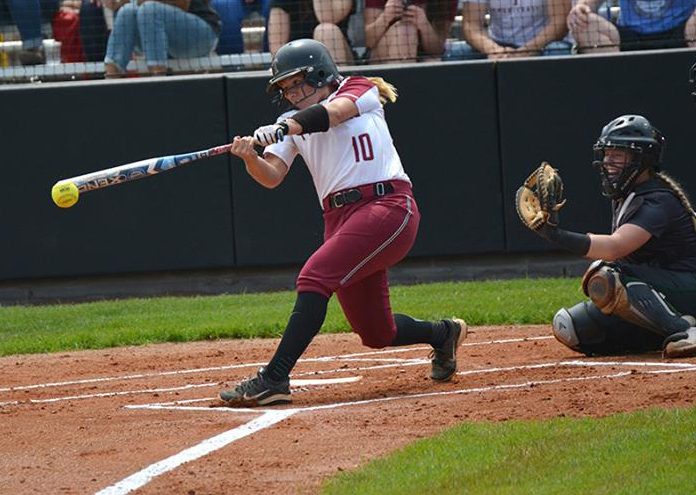 softball batter swings at a ball