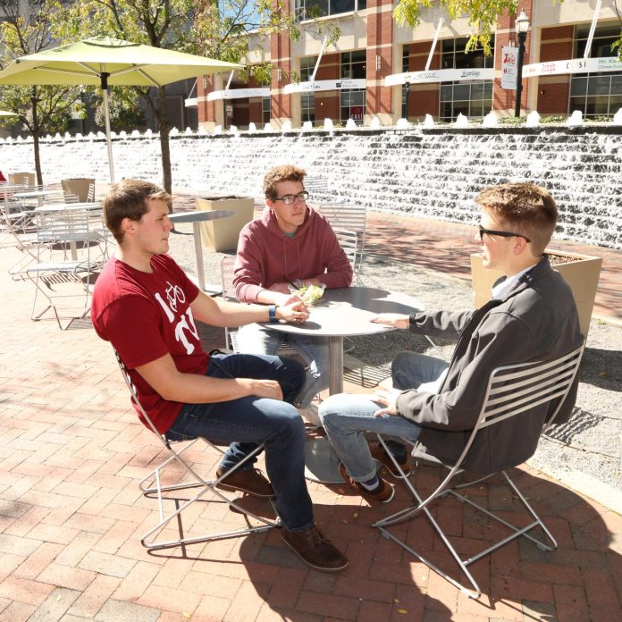 transylvania students sitting at a table in lexington's triangle park